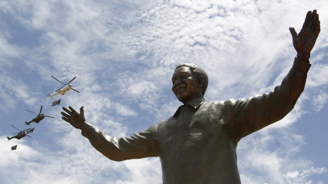 Helicopters fly past a 9-metre bronze statue of the Nelson Mandela after it was unveiled as part of the Day of Reconciliation Celebrations at the Union Buildings in Pretoria